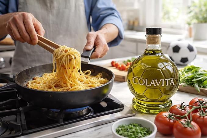 Person cooking pasta with Colavita olive oil bottle on a kitchen counter.